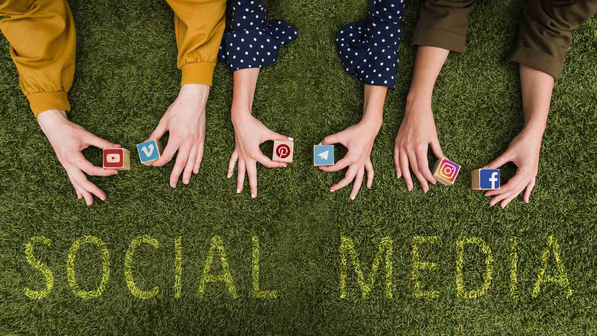 a group of hands holding small cubes for social media marketing for business